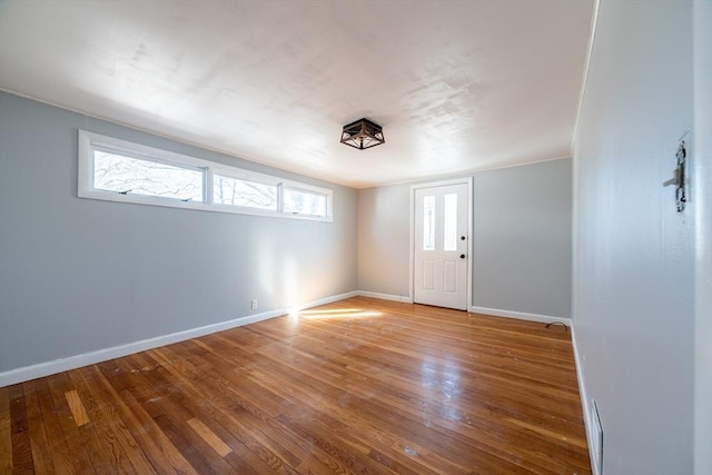 interior space featuring baseboards and hardwood / wood-style floors