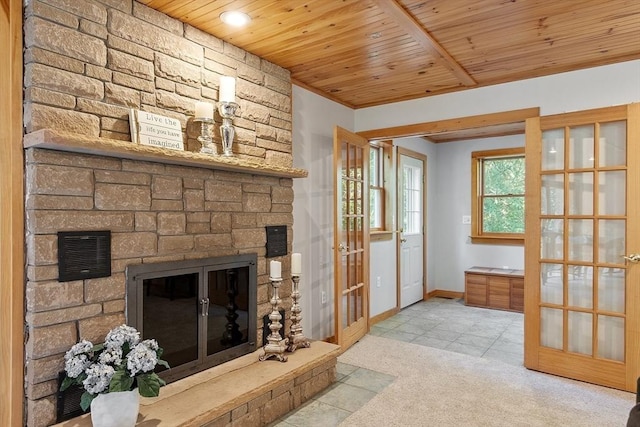 1 Sheffield Cir, Andover, MA 01810 - carpeted living area featuring french doors, wood ceiling, a stone fireplace, tile patterned floors, and recessed lighting