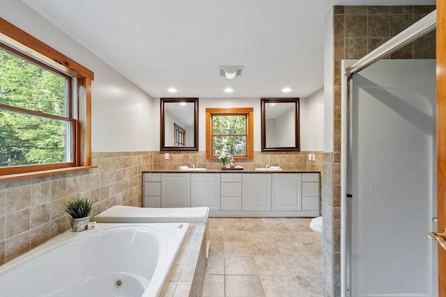 1 Sheffield Cir, Andover, MA 01810 - bathroom featuring double vanity, a jetted tub, tile walls, a shower stall, and recessed lighting