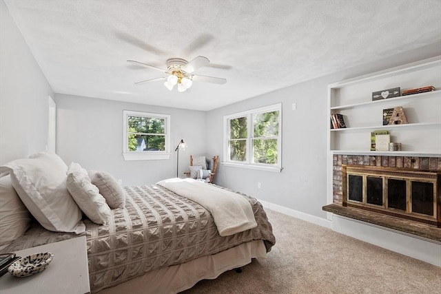 1 Sheffield Cir, Andover, MA 01810 - bedroom with carpet floors, ceiling fan, a textured ceiling, and a brick fireplace
