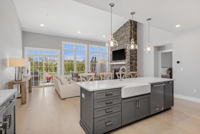 21 Brand Blvd Unit 21, Scituate, MA 02066 - kitchen with a sink, open floor plan, gray cabinets, light countertops, and light wood-style floors