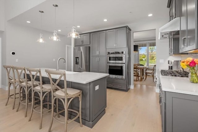 21 Brand Blvd Unit 21, Scituate, MA 02066 - kitchen with stainless steel appliances, gray cabinets, light wood-type flooring, light countertops, and recessed lighting