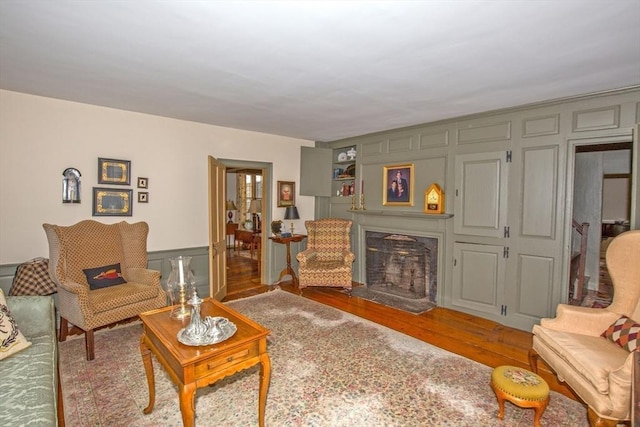 living area featuring a high end fireplace and wood finished floors