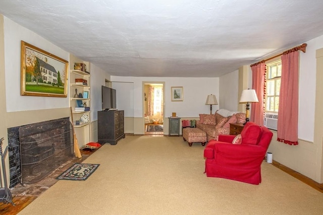 carpeted living room featuring a tiled fireplace