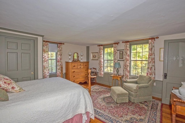 bedroom featuring baseboards and wood finished floors
