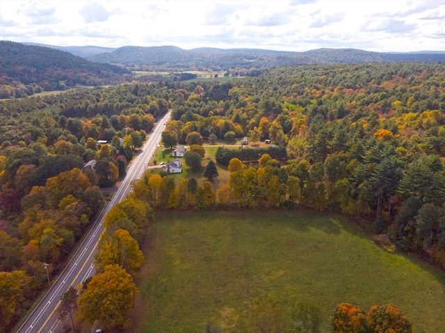 drone / aerial view featuring a mountain view and a wooded view
