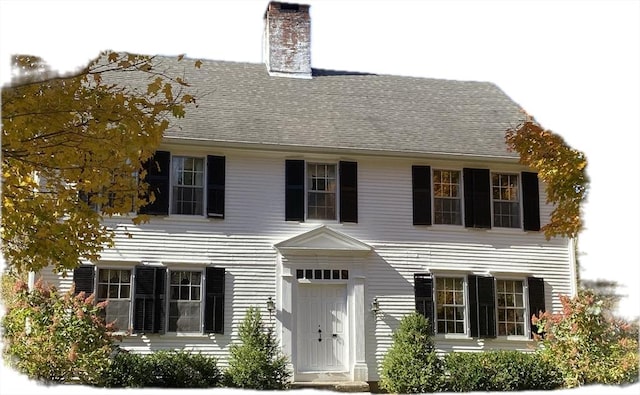 colonial inspired home featuring a chimney