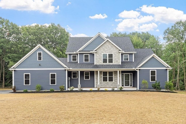 168 Justice Hill Rd Oakmont, Unit Oakmont, Sterling, MA 01564 - view of front of property with stone siding, a shingled roof, a front yard, and covered porch