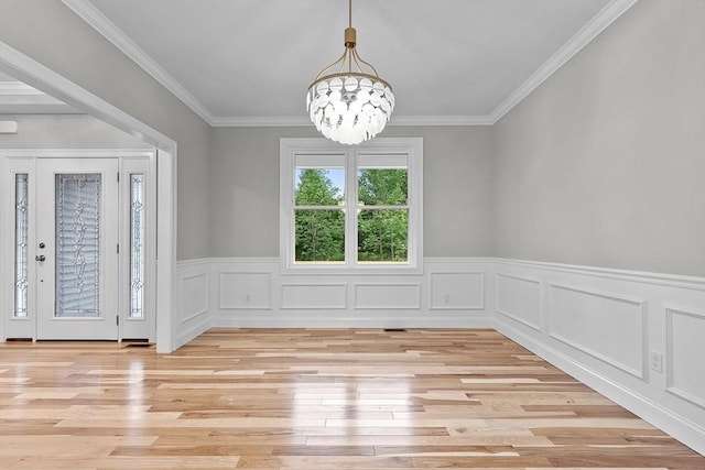 168 Justice Hill Rd Oakmont, Unit Oakmont, Sterling, MA 01564 - unfurnished dining area featuring light wood finished floors, a chandelier, wainscoting, and crown molding