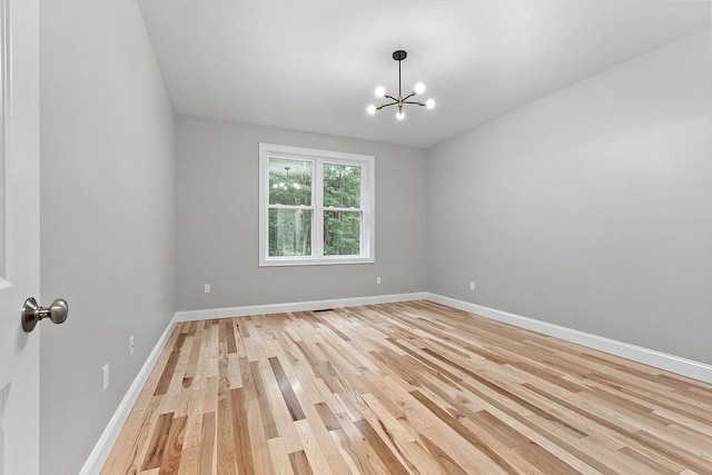 168 Justice Hill Rd Oakmont, Unit Oakmont, Sterling, MA 01564 - spare room with light wood-type flooring, a chandelier, and baseboards
