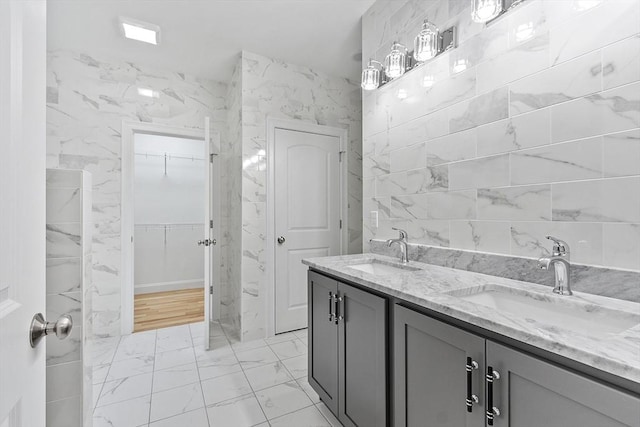 168 Justice Hill Rd Oakmont, Unit Oakmont, Sterling, MA 01564 - bathroom featuring marble look tiles, a walk in closet, and double vanity