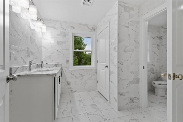 168 Justice Hill Rd Oakmont, Unit Oakmont, Sterling, MA 01564 - bathroom with marble finish floors, vanity, tile walls, and toilet