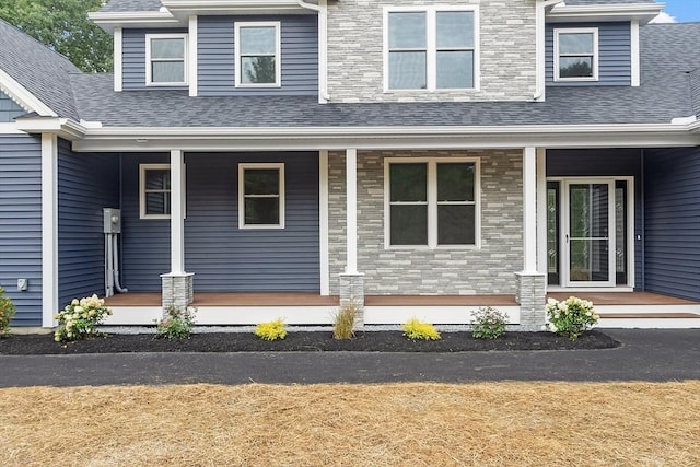 168 Justice Hill Rd Oakmont, Unit Oakmont, Sterling, MA 01564 - view of front of house featuring covered porch, roof with shingles, and stone siding