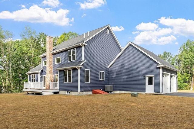 168 Justice Hill Rd Oakmont, Unit Oakmont, Sterling, MA 01564 - rear view of property featuring a chimney, a lawn, a wooden deck, a garage, and asphalt driveway
