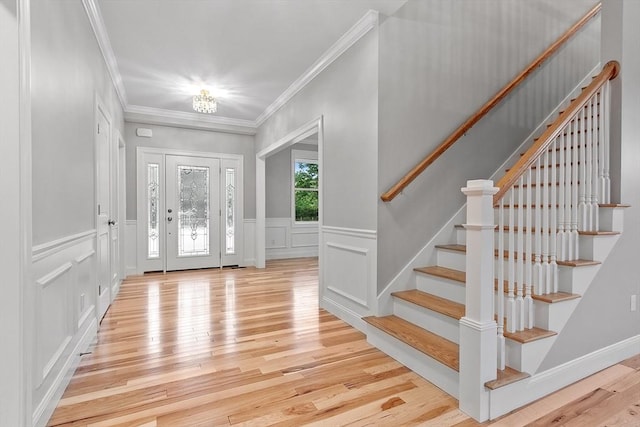 168 Justice Hill Rd Oakmont, Unit Oakmont, Sterling, MA 01564 - entryway featuring light wood finished floors, a decorative wall, ornamental molding, stairs, and a wainscoted wall