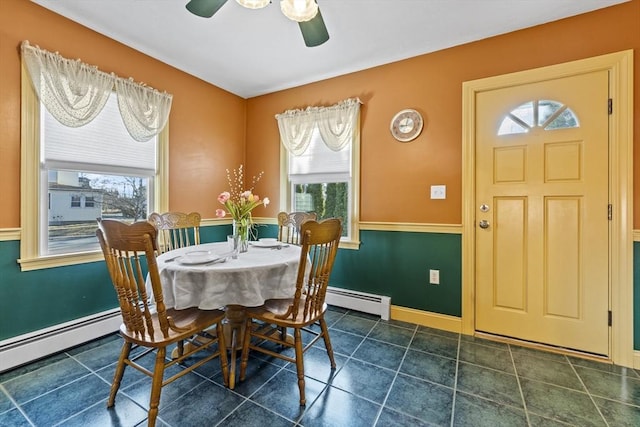 dining room featuring baseboards, plenty of natural light, baseboard heating, and tile patterned flooring