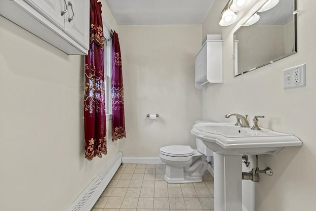 bathroom with tile patterned floors, toilet, baseboards, and baseboard heating