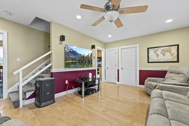 living area with stairway, recessed lighting, wood finished floors, and baseboards