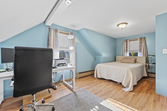 bedroom with a baseboard radiator, multiple windows, and wood finished floors