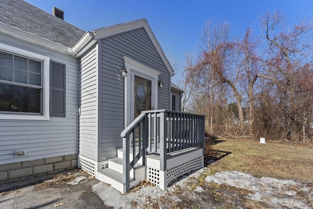 exterior space featuring crawl space and a shingled roof