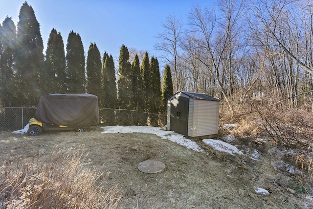 view of yard with a shed, an outdoor structure, and a fenced backyard