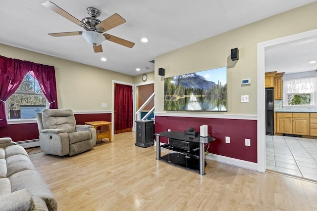 living room with baseboards, ceiling fan, baseboard heating, recessed lighting, and light wood-style floors