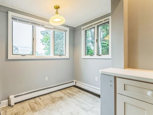 328 E Main St, Marlborough, MA 01752 - empty room featuring a baseboard heating unit, light wood finished floors, and baseboards