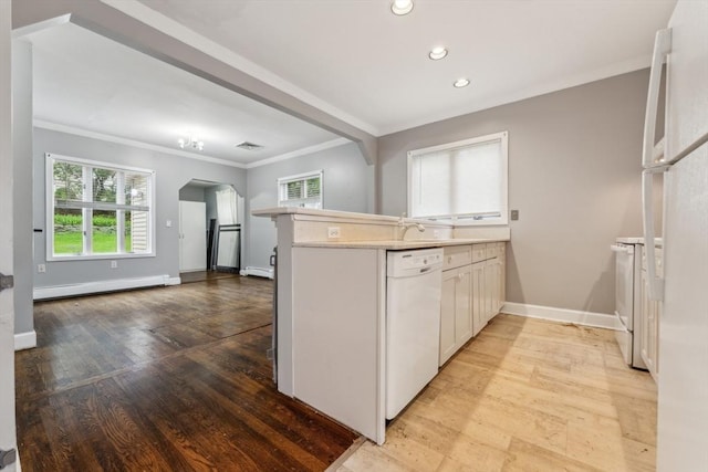 328 E Main St, Marlborough, MA 01752 - kitchen featuring white appliances, a baseboard radiator, a peninsula, arched walkways, and crown molding