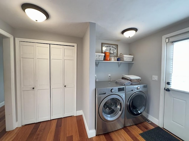 laundry area featuring separate washer and dryer and hardwood / wood-style floors