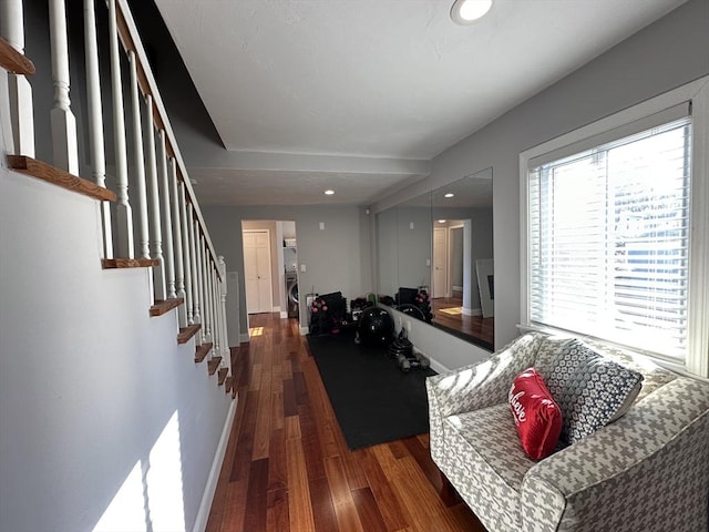 living room featuring dark hardwood / wood-style flooring and washer / dryer