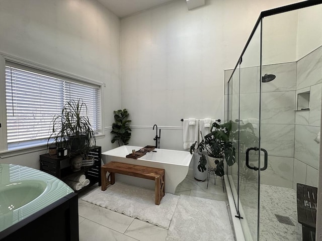 bathroom with separate shower and tub and vanity