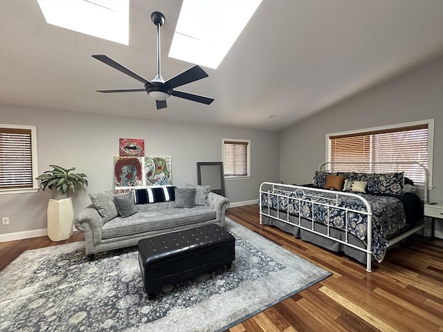 bedroom with ceiling fan, multiple windows, and wood-type flooring