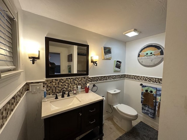 bathroom with tile patterned floors, vanity, and toilet