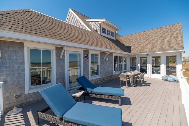 deck with outdoor dining area and french doors
