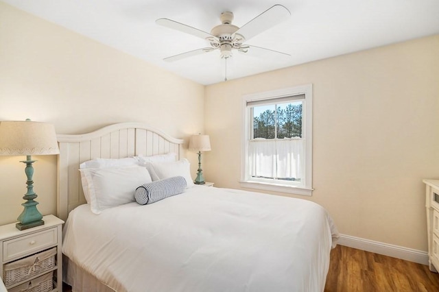 bedroom with baseboards, wood finished floors, and a ceiling fan