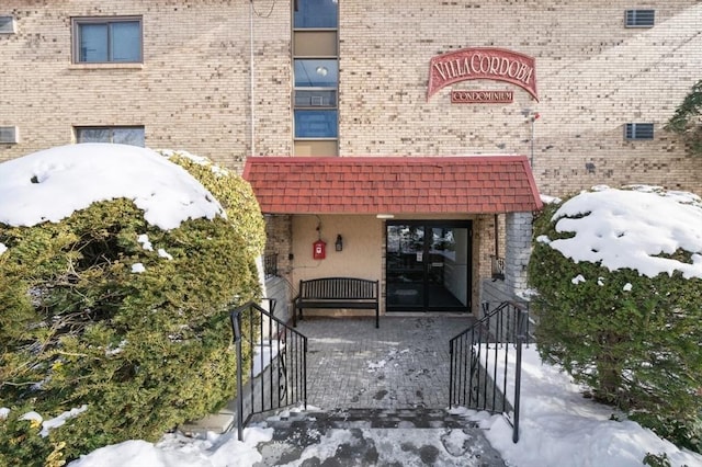 view of snow covered property entrance