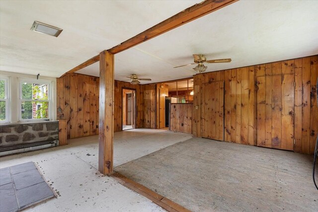 21 City Depot Rd, Charlton, MA 01507 - unfurnished living room with wood walls, ceiling fan, and a baseboard radiator