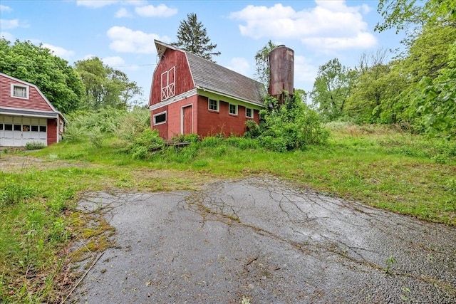 21 City Depot Rd, Charlton, MA 01507 - view of property exterior with a barn, a gambrel roof, a detached garage, an outdoor structure, and a chimney