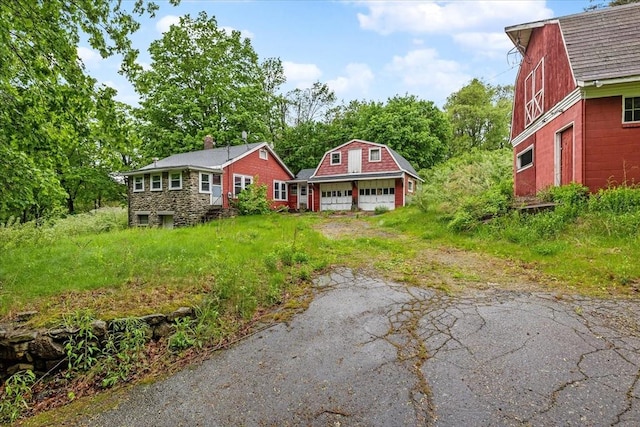 21 City Depot Rd, Charlton, MA 01507 - view of front of house featuring a gambrel roof, an outdoor structure, a garage, and driveway