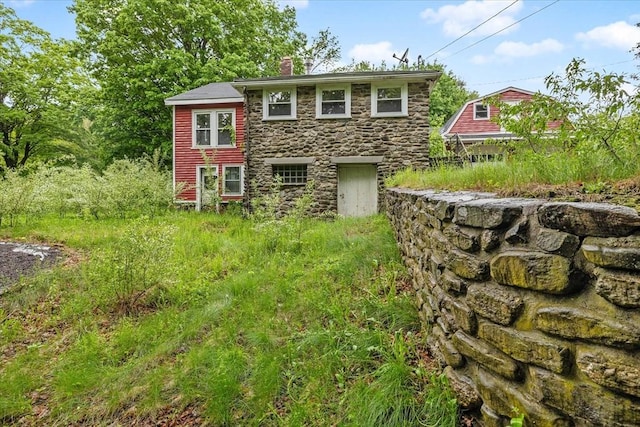21 City Depot Rd, Charlton, MA 01507 - rear view of property with stone siding and a chimney