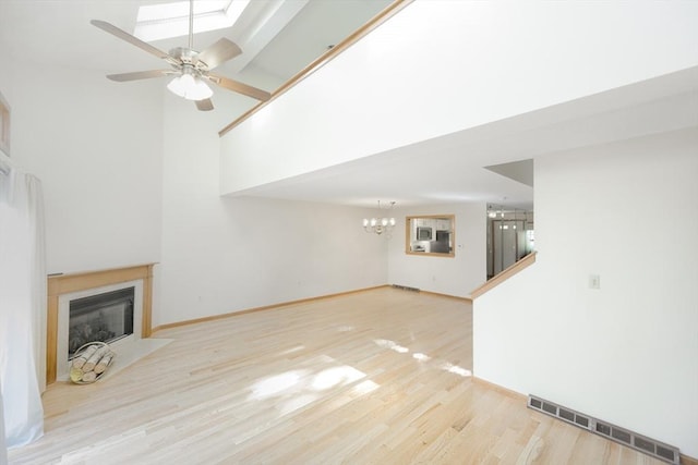 19 Spruce Pond Rd Unit 19, Franklin, MA 02038 - unfurnished living room with a fireplace with flush hearth, wood finished floors, a chandelier, ceiling fan, and baseboards