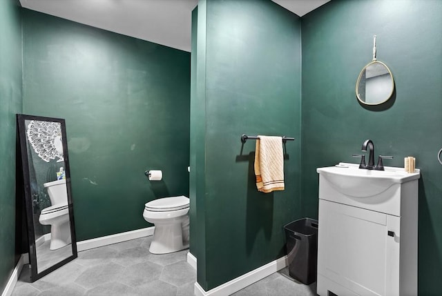 17 Kearney Sq Unit 209, Lowell, MA 01852 - bathroom with toilet, baseboards, and vanity