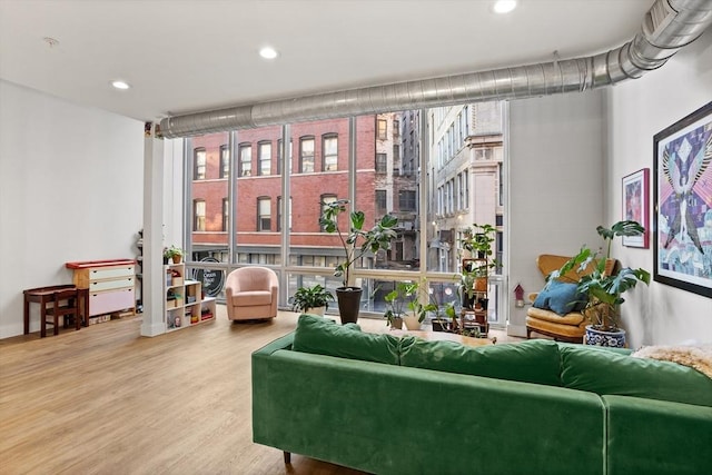 17 Kearney Sq Unit 209, Lowell, MA 01852 - living area with floor to ceiling windows, wood finished floors, healthy amount of natural light, and recessed lighting