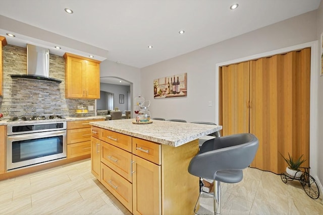540 Rivet St, New Bedford, MA 02740 - kitchen with stainless steel oven, wall chimney exhaust hood, recessed lighting, backsplash, and gas cooktop