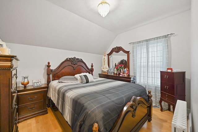 540 Rivet St, New Bedford, MA 02740 - bedroom featuring radiator, light wood-style floors, and vaulted ceiling