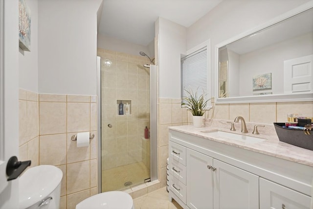 540 Rivet St, New Bedford, MA 02740 - bathroom with tile walls, toilet, vanity, a stall shower, and tile patterned flooring