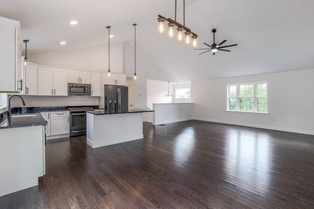 40 Jackson Ln, Barre, MA 01005 - kitchen featuring stainless steel microwave, refrigerator with ice dispenser, a sink, stove, and dark countertops