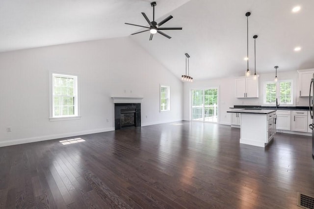 40 Jackson Ln, Barre, MA 01005 - unfurnished living room with a ceiling fan, high vaulted ceiling, dark wood finished floors, a sink, and a glass covered fireplace