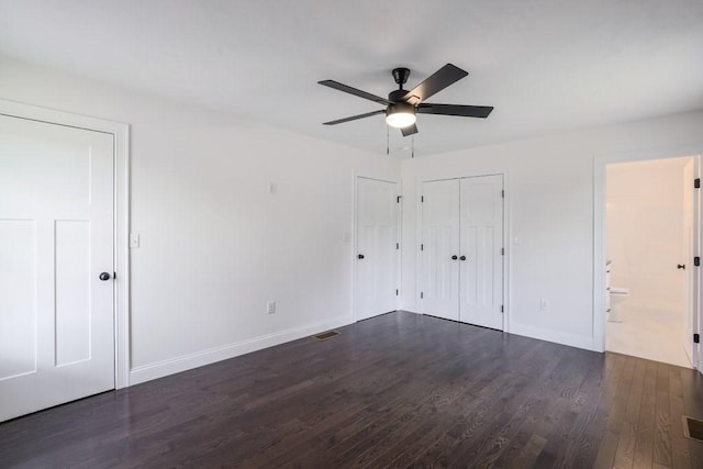 40 Jackson Ln, Barre, MA 01005 - unfurnished bedroom with dark wood-style flooring, baseboards, connected bathroom, and ceiling fan