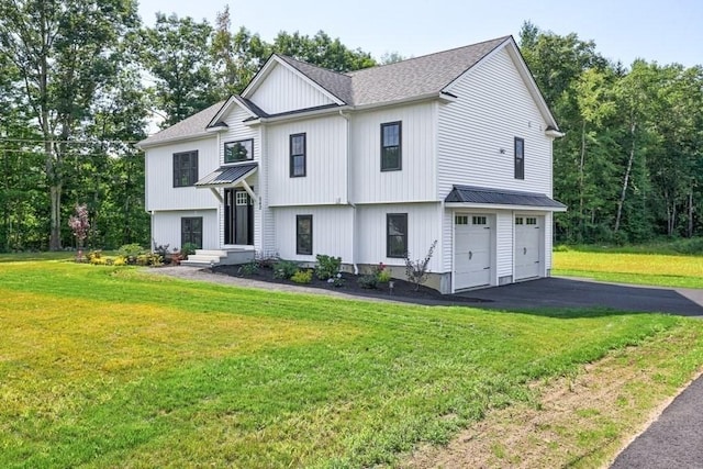 40 Jackson Ln, Barre, MA 01005 - view of front of home with asphalt driveway, metal roof, a garage, and a front yard